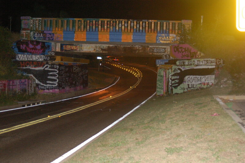 graffiti-covered bridge at night