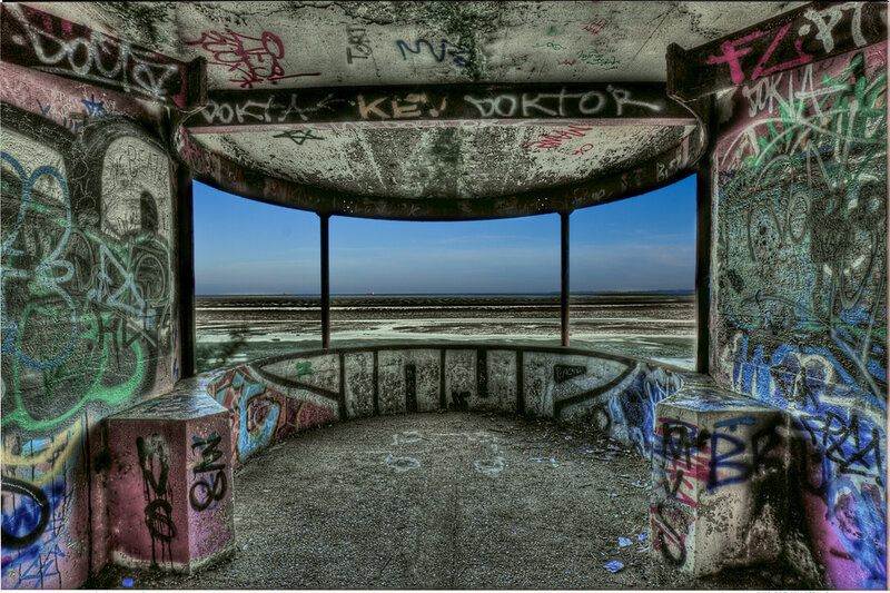 graffiti-covered bunker overlooking the sea