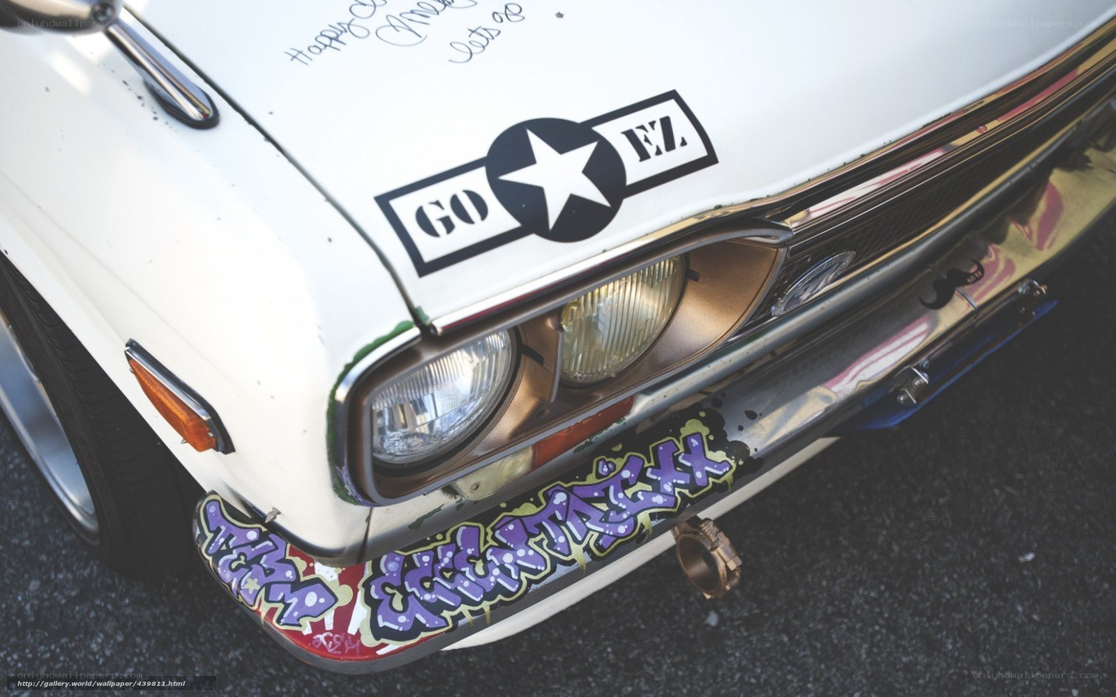 graffiti-covered car front