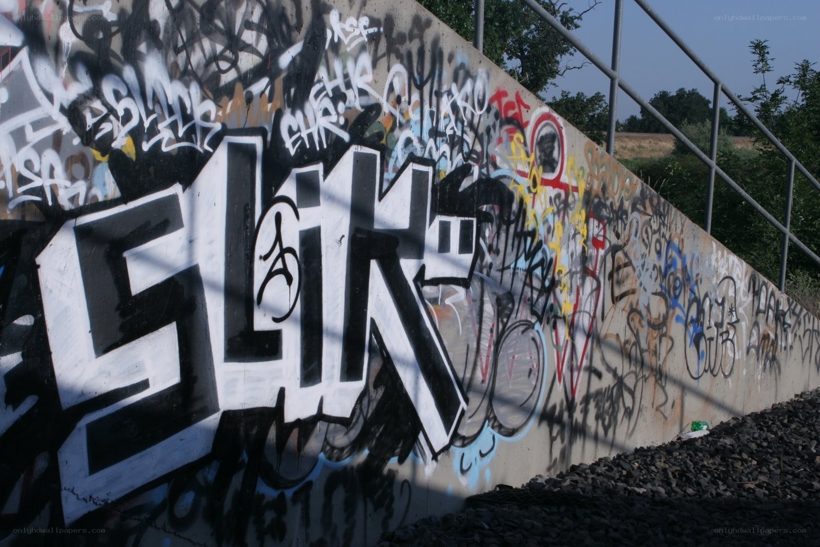 graffiti-covered concrete wall