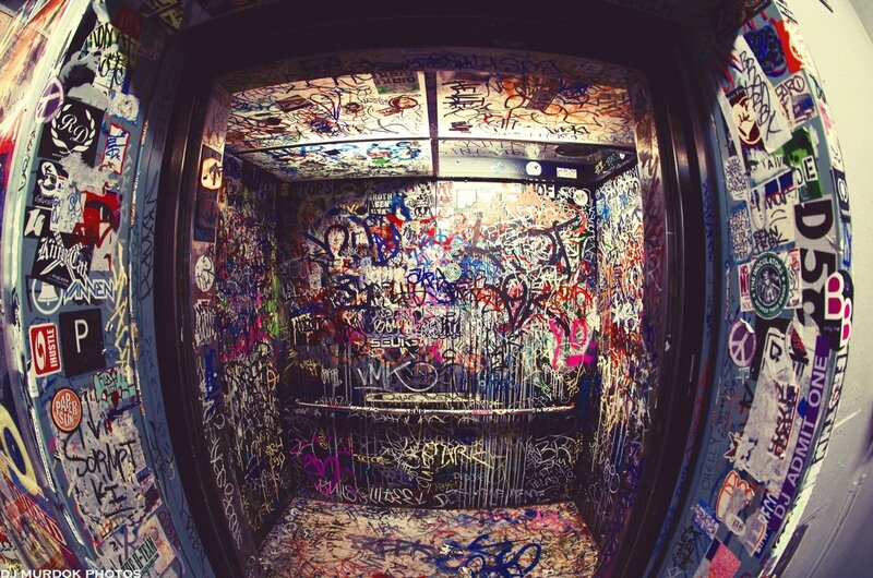 graffiti-covered elevator interior