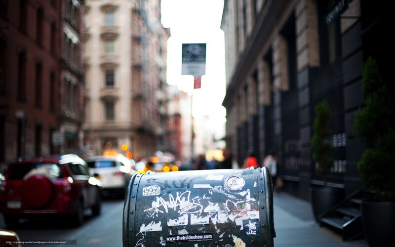 graffiti-covered mailbox on city street