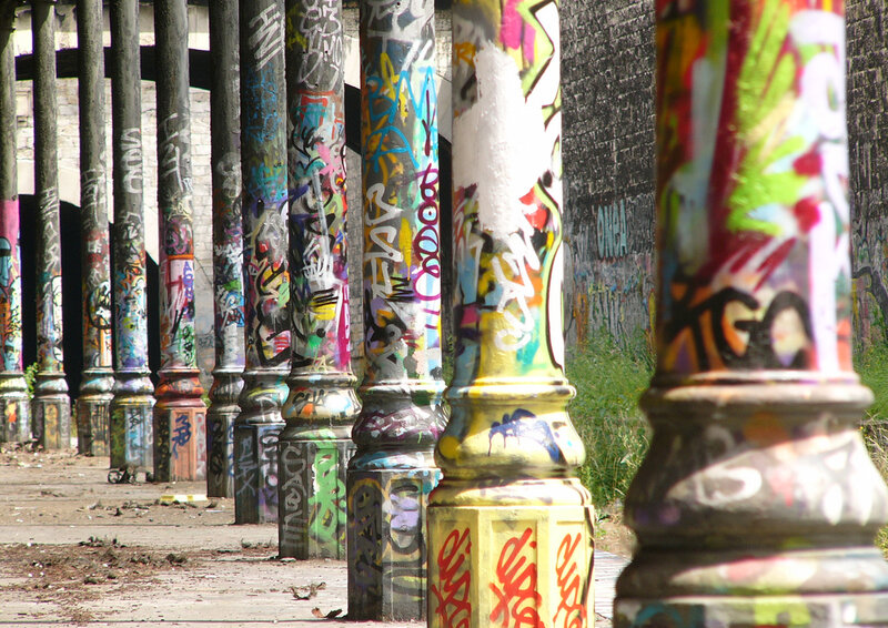 graffiti-covered pillars in an urban space