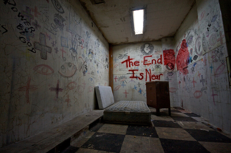 graffiti-covered prison cell