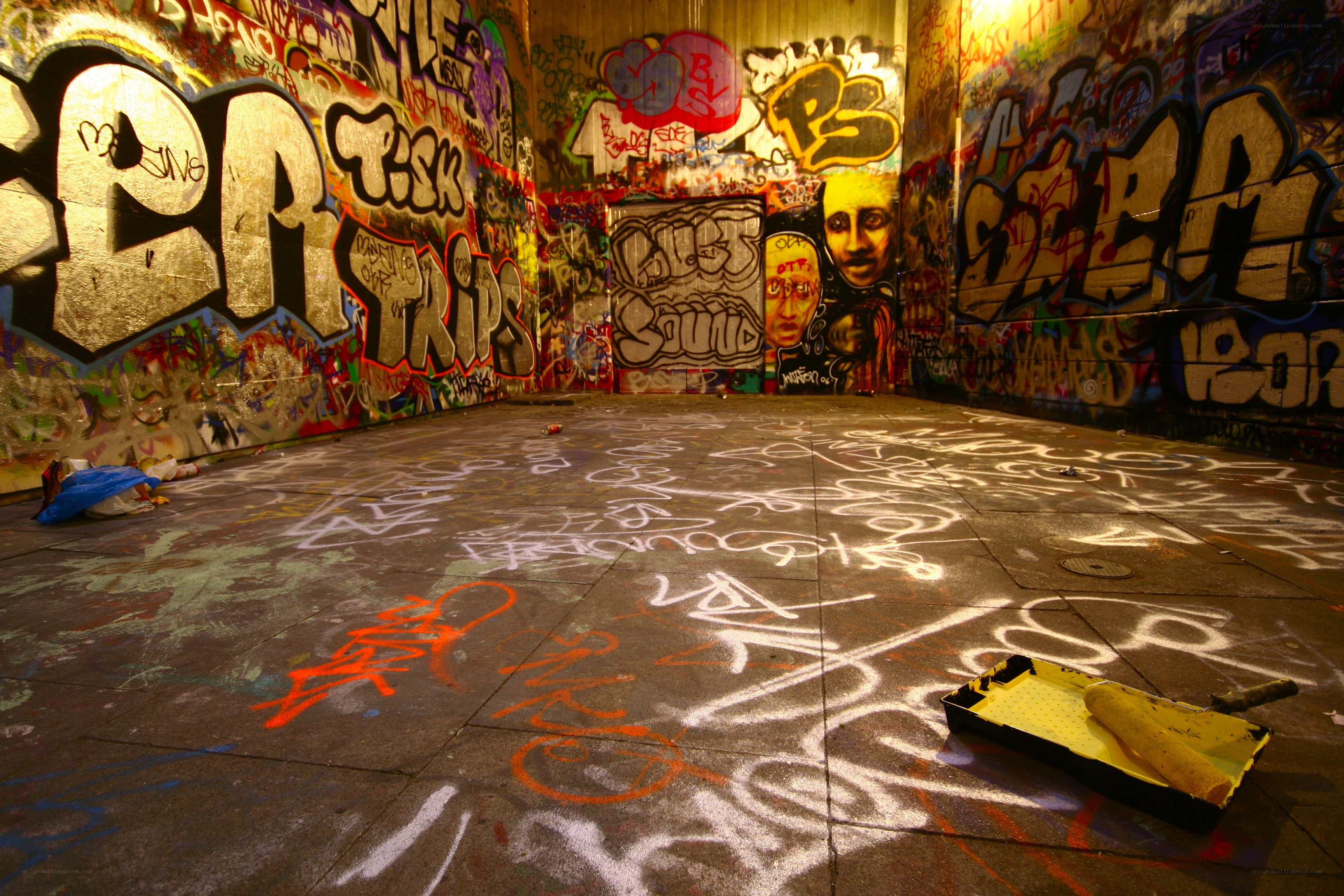 graffiti-covered room with paint tray