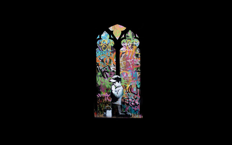 graffiti-covered stained glass window