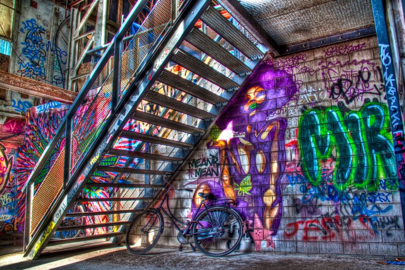 graffiti-covered staircase with bicycle