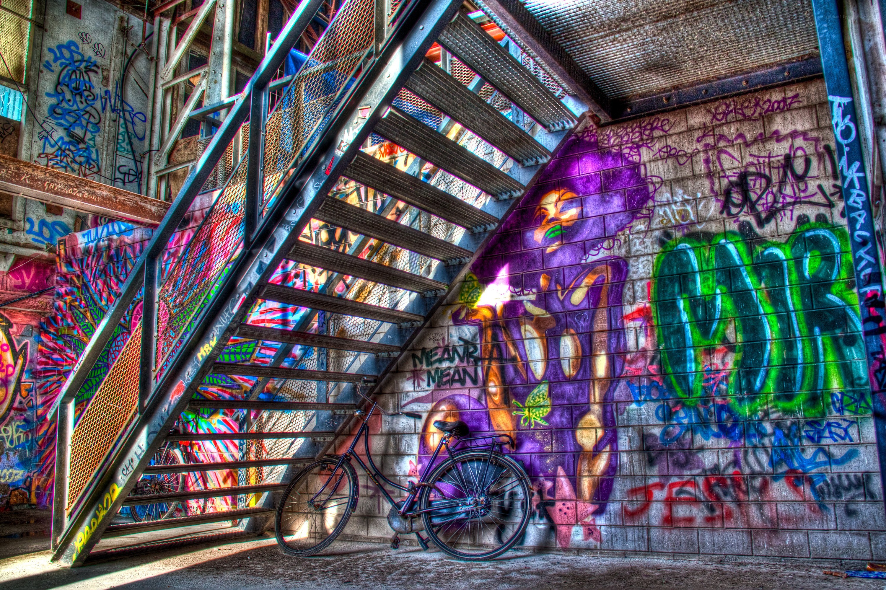graffiti-covered staircase with bicycle