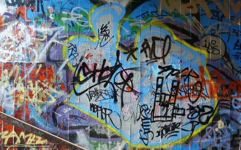 graffiti-covered tiled wall