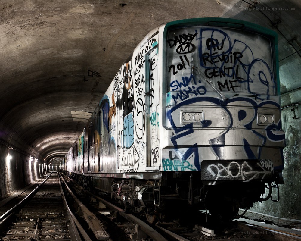 graffiti-covered train in tunnel