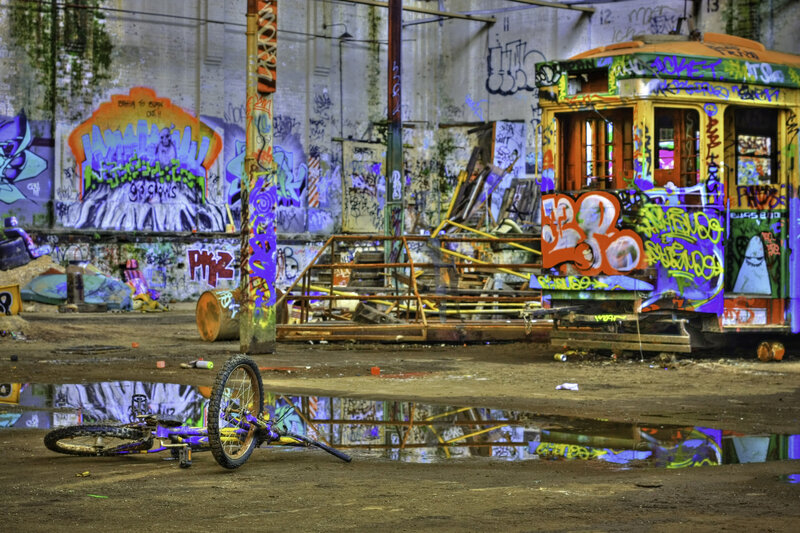 graffiti-covered trolley in abandoned lot