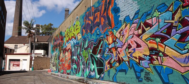 Graffiti-covered Wall — Blue, Vibrant, Afternoon
