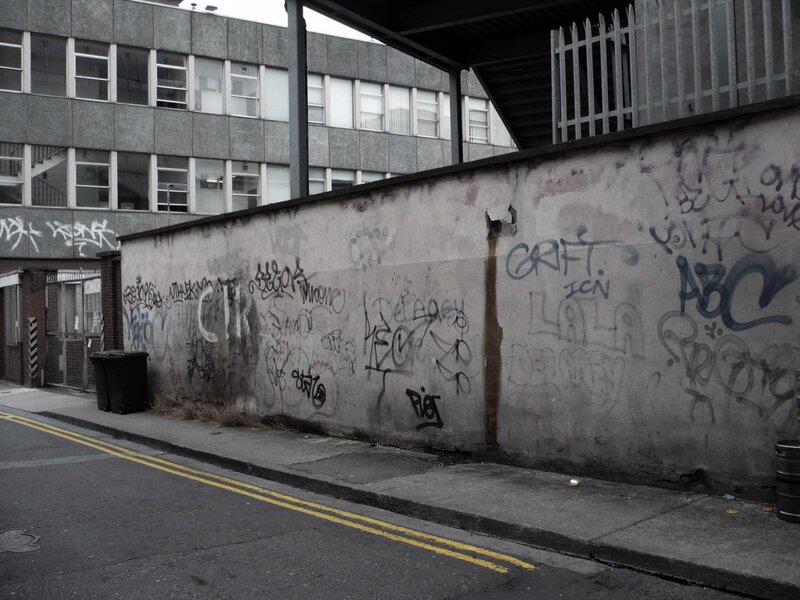 graffiti-covered wall in urban alley