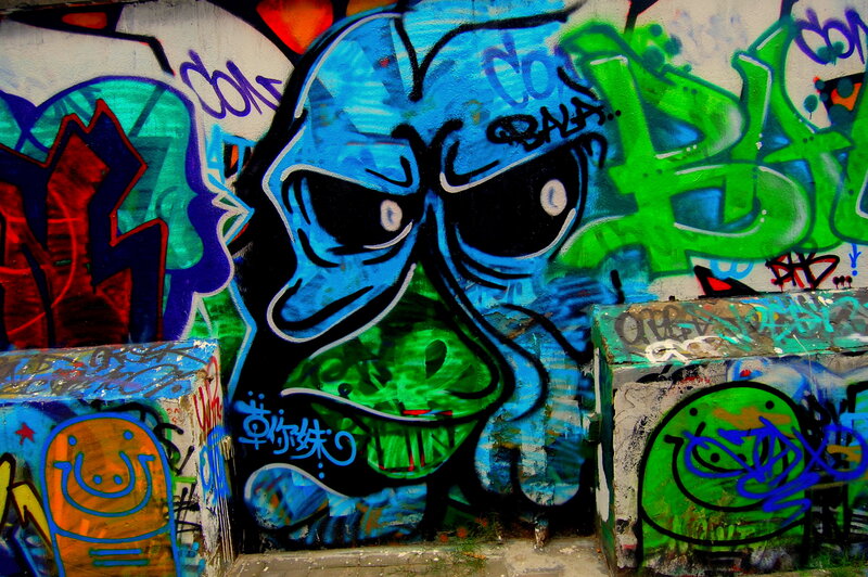 graffiti-covered wall with blue character