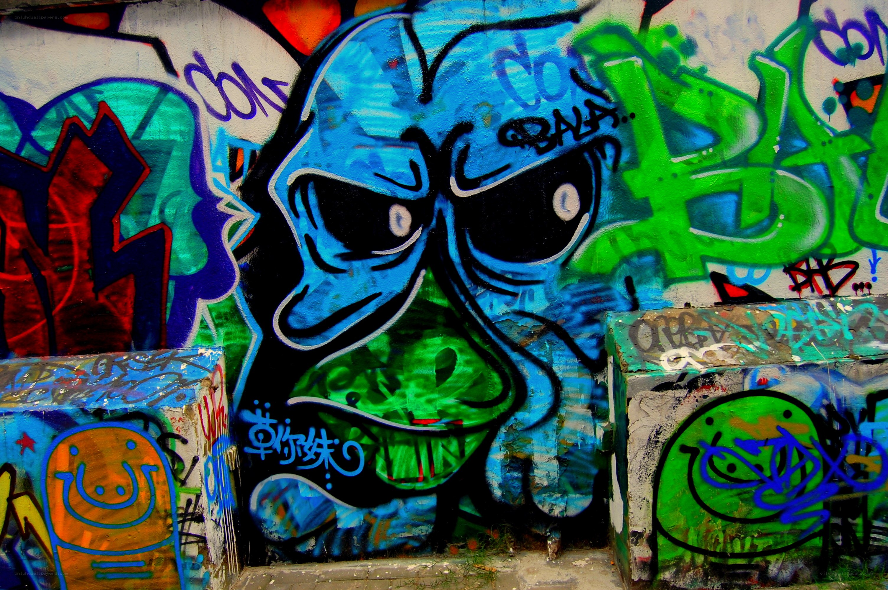 graffiti-covered wall with blue character