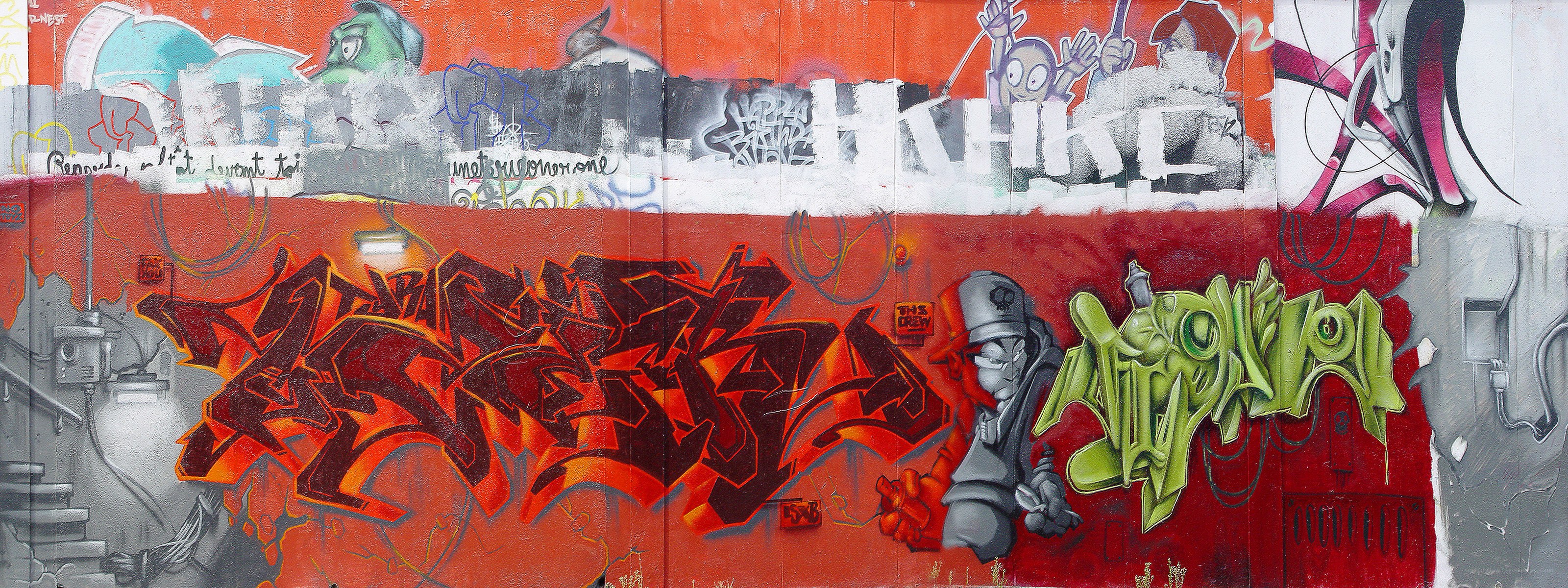 graffiti-covered wall with characters
