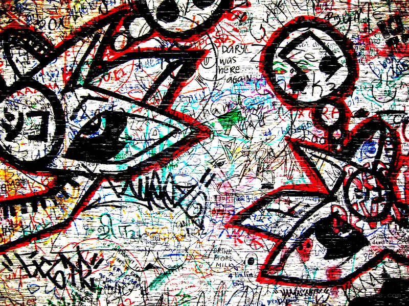 graffiti-covered wall with eyes