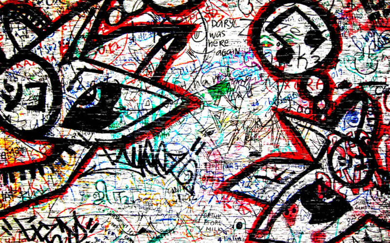 graffiti-covered wall with eyes