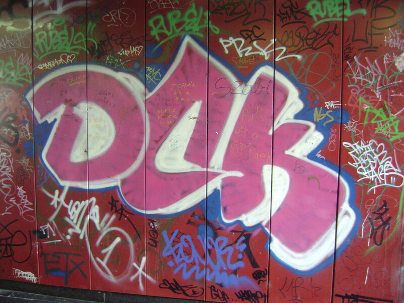graffiti-covered wall with pink letters
