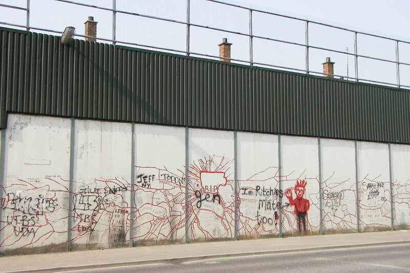 graffiti-covered wall with red figure