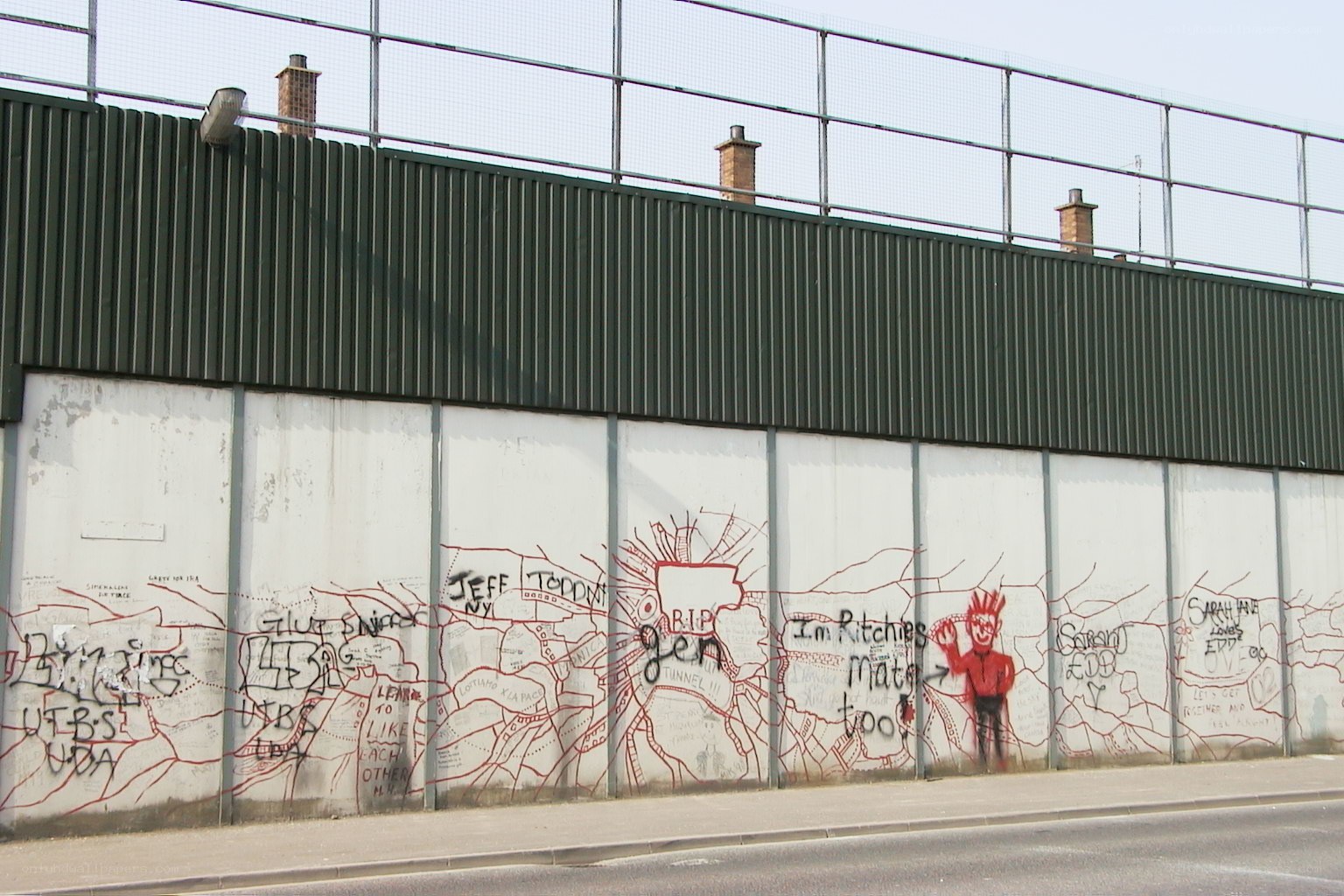 graffiti-covered wall with red figure