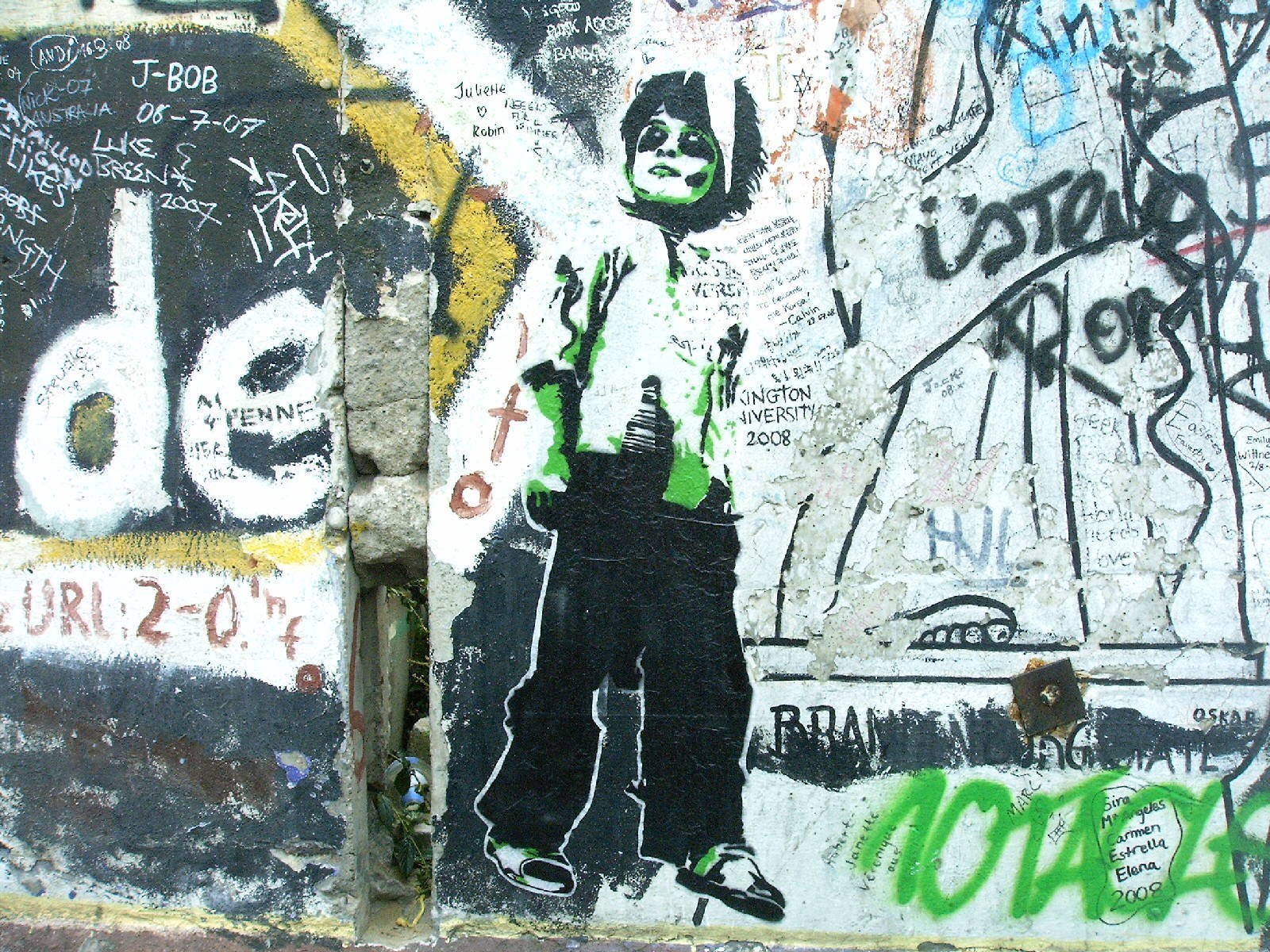graffiti-covered wall with stencil art