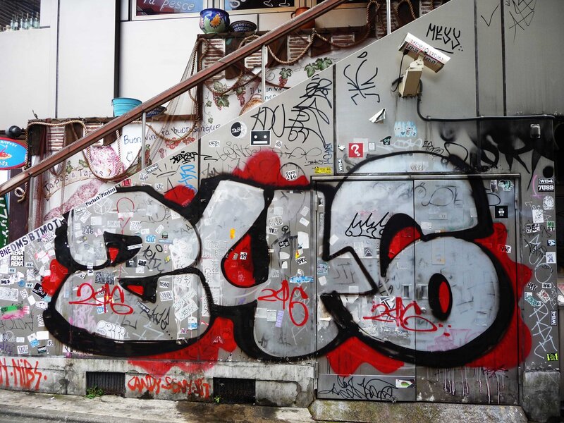 graffiti-covered wall with street art