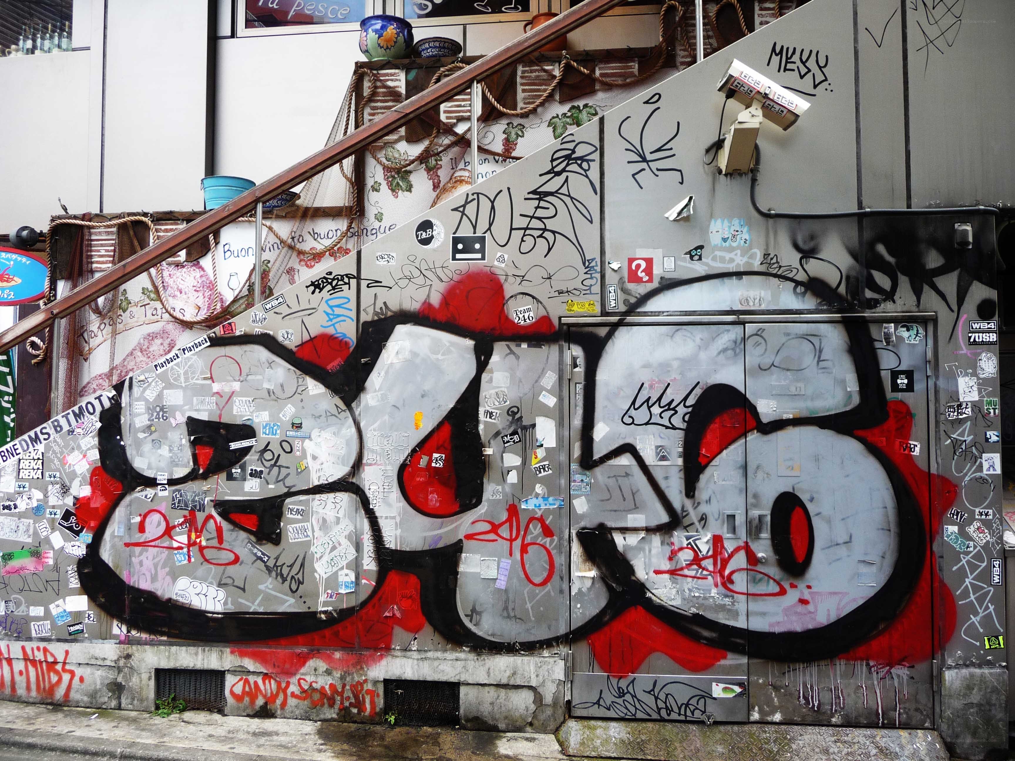 graffiti-covered wall with street art
