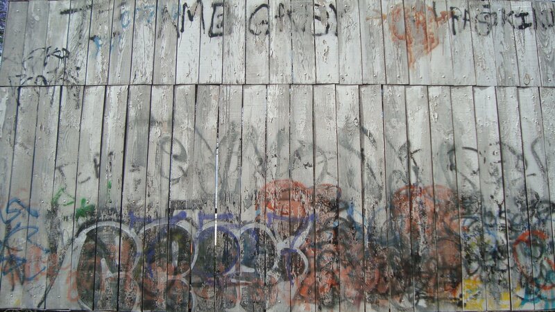 graffiti-covered wooden fence