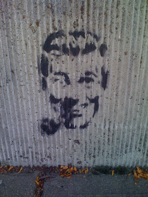 graffiti face on concrete wall