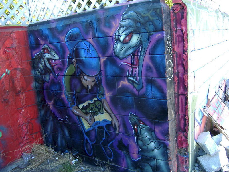 graffiti mural of figure with snakes
