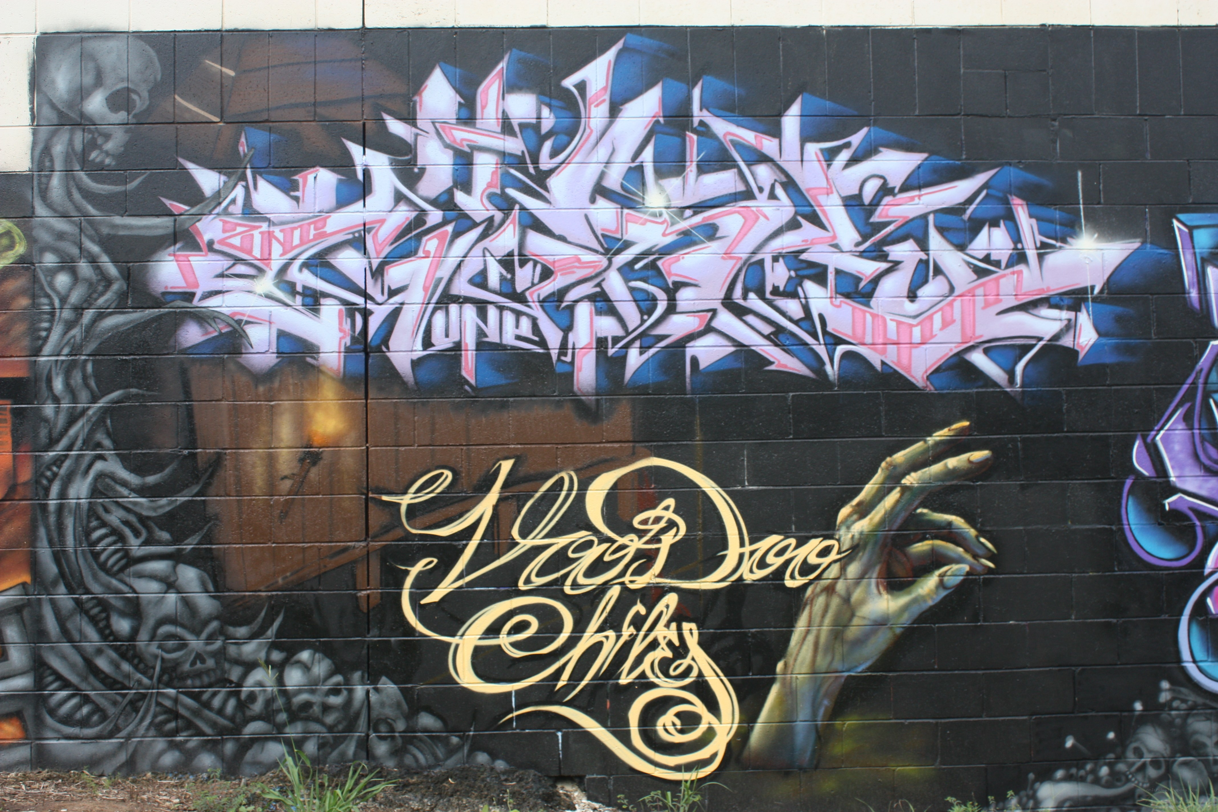graffiti mural with skulls and hand