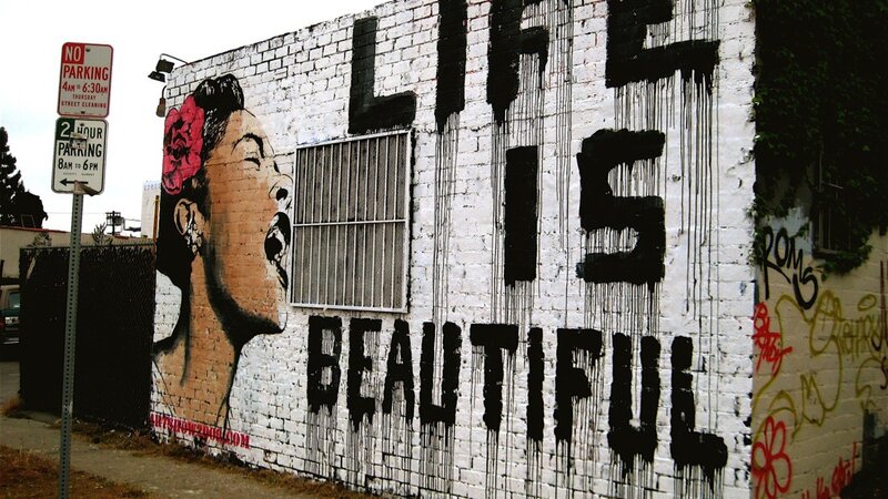 graffiti mural with woman and text