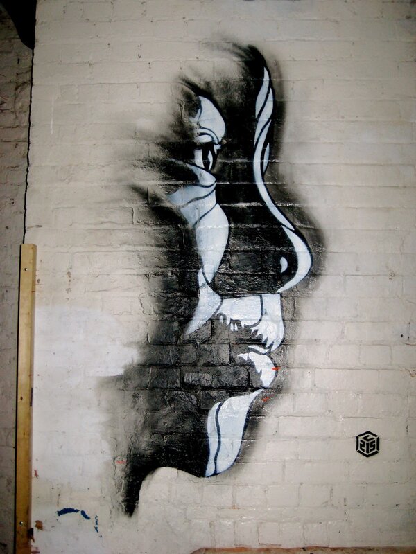 graffiti of a face on brick wall
