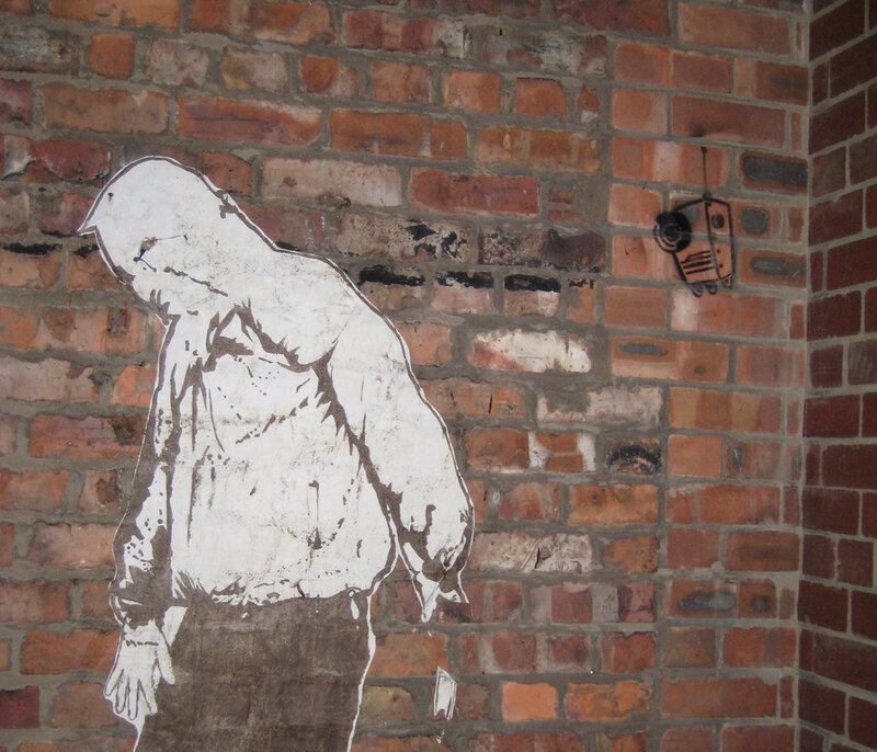 graffiti of a figure on brick wall