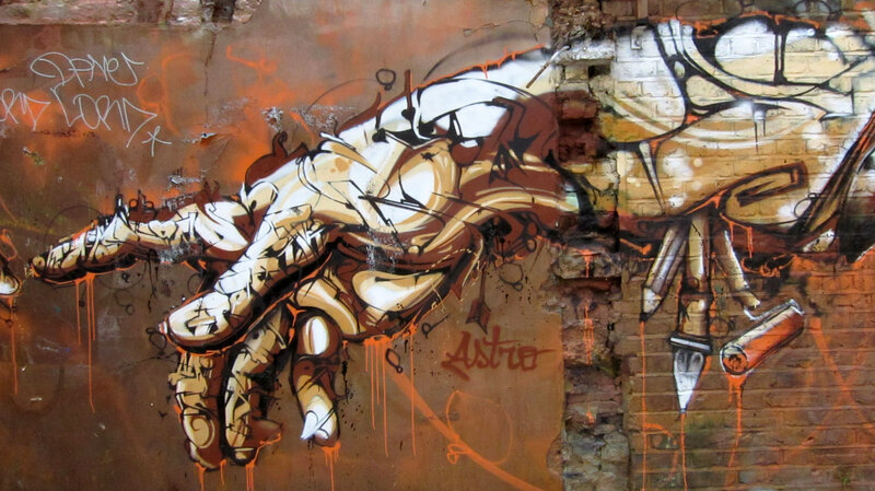 graffiti of a hand on brick