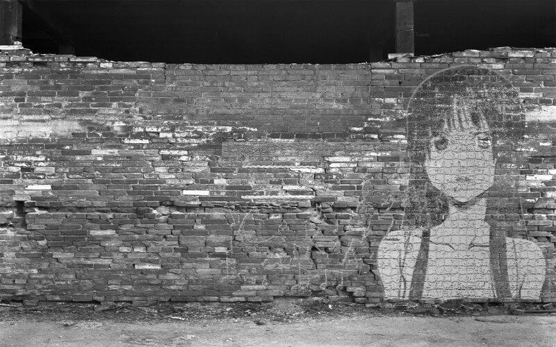 graffiti of girl on brick wall