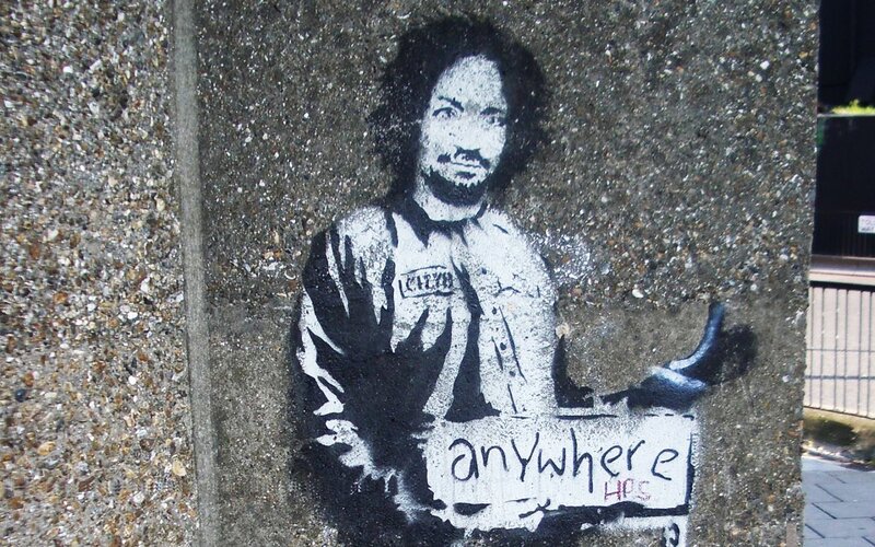 graffiti of man holding sign