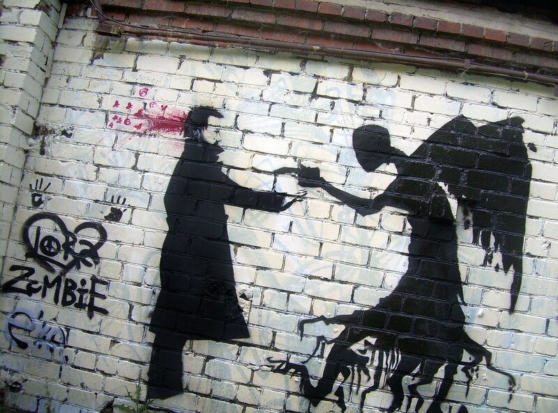 graffiti of man shooting angel
