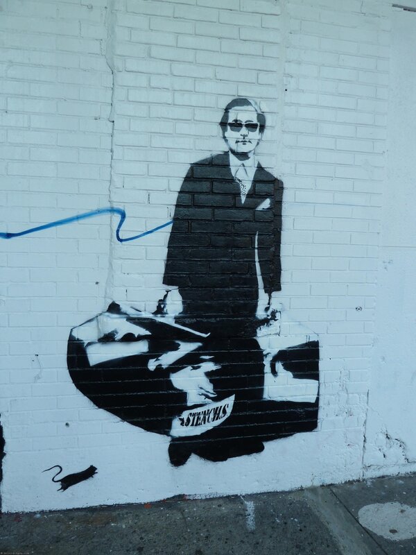 graffiti of man with suitcase