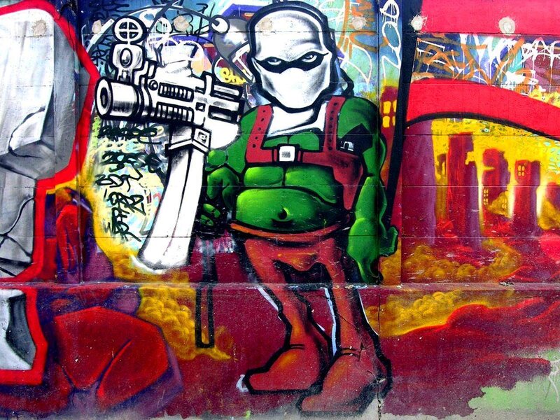 graffiti of masked figure with gun