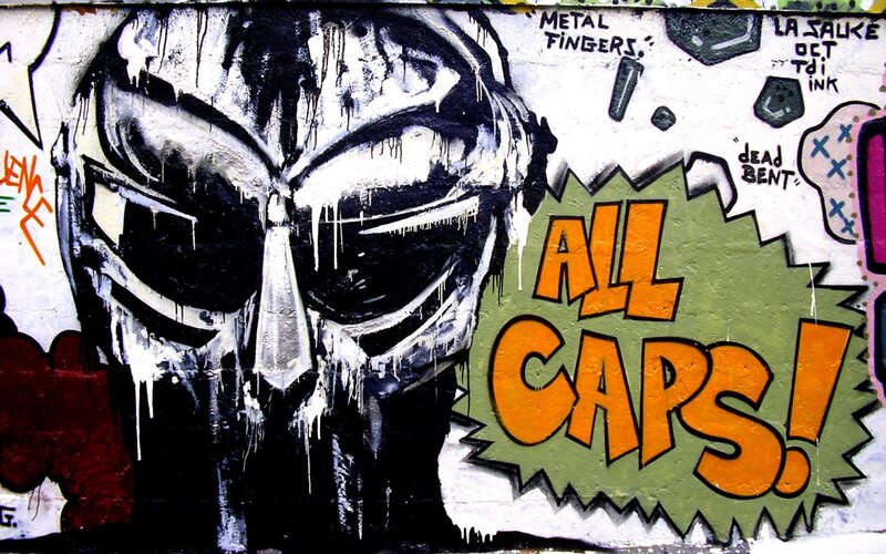 graffiti of masked figure with text
