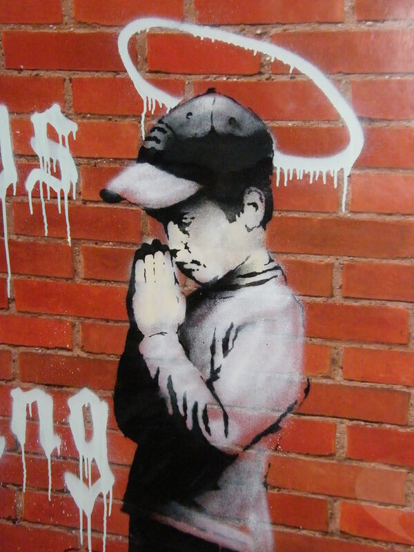 graffiti of praying boy