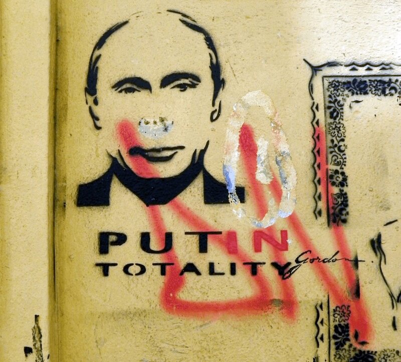 graffiti of putin with 'totality' text