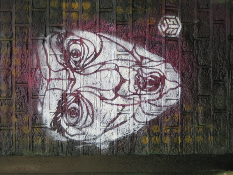 graffiti of roses on brick wall
