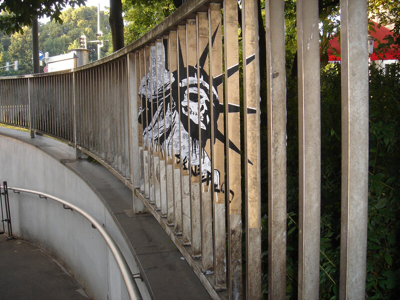 graffiti of skull statue on railing