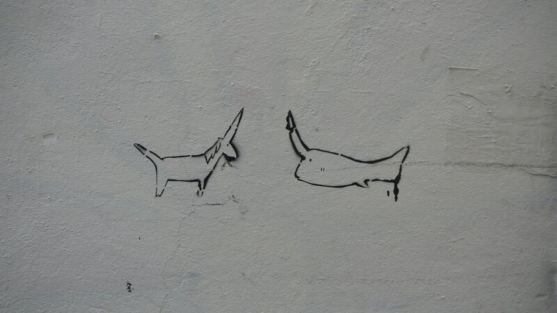 graffiti of two dogs on wall