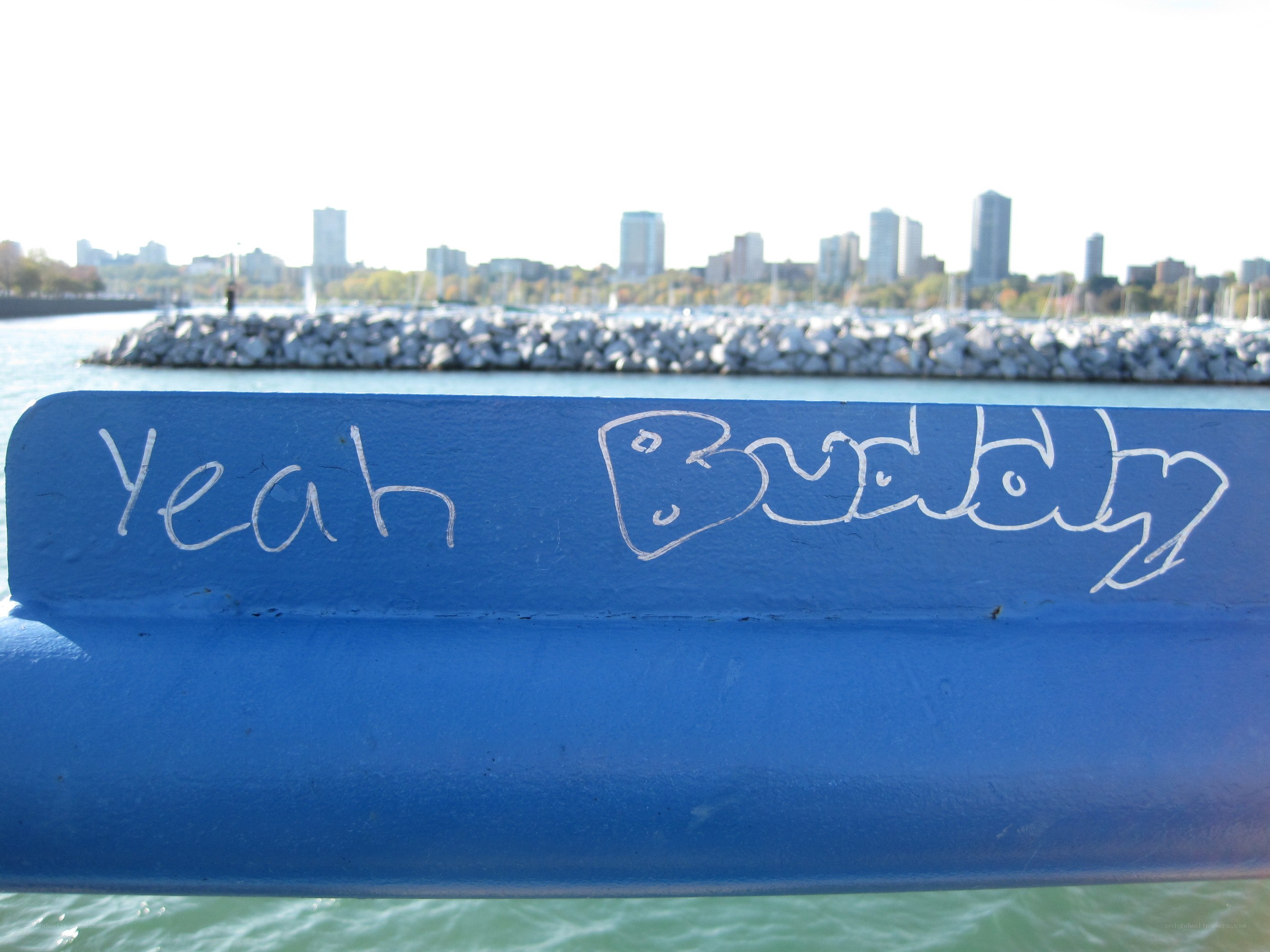 graffiti on a blue railing
