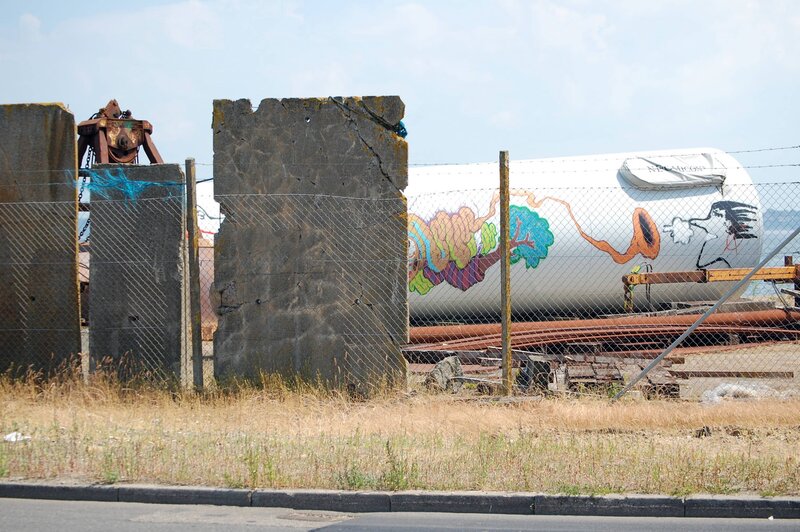 graffiti on a tank at a dock