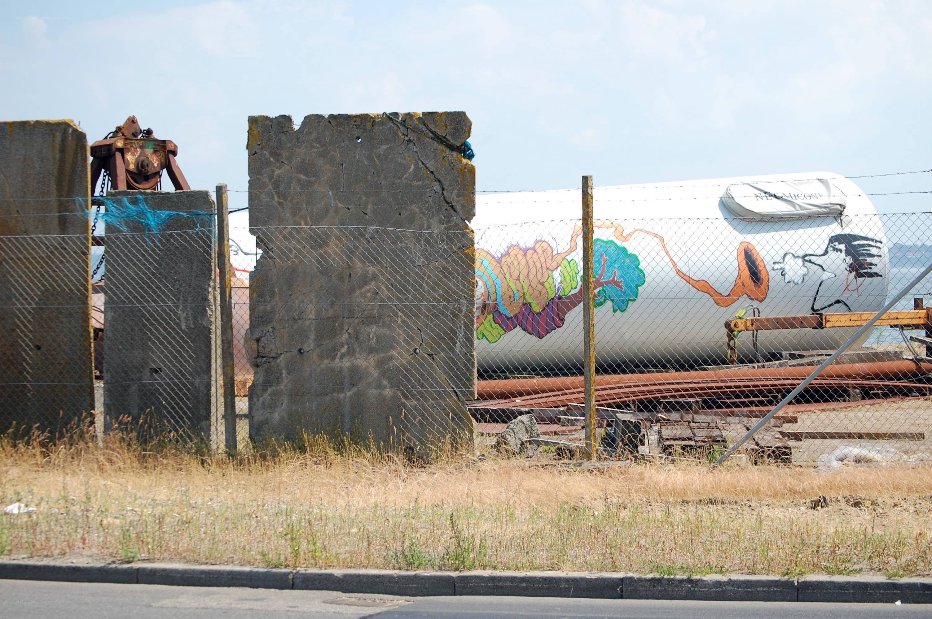 graffiti on a tank at a dock